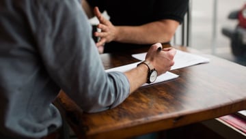 Building the business case for online proofing: marketers working on a creative project on a paper