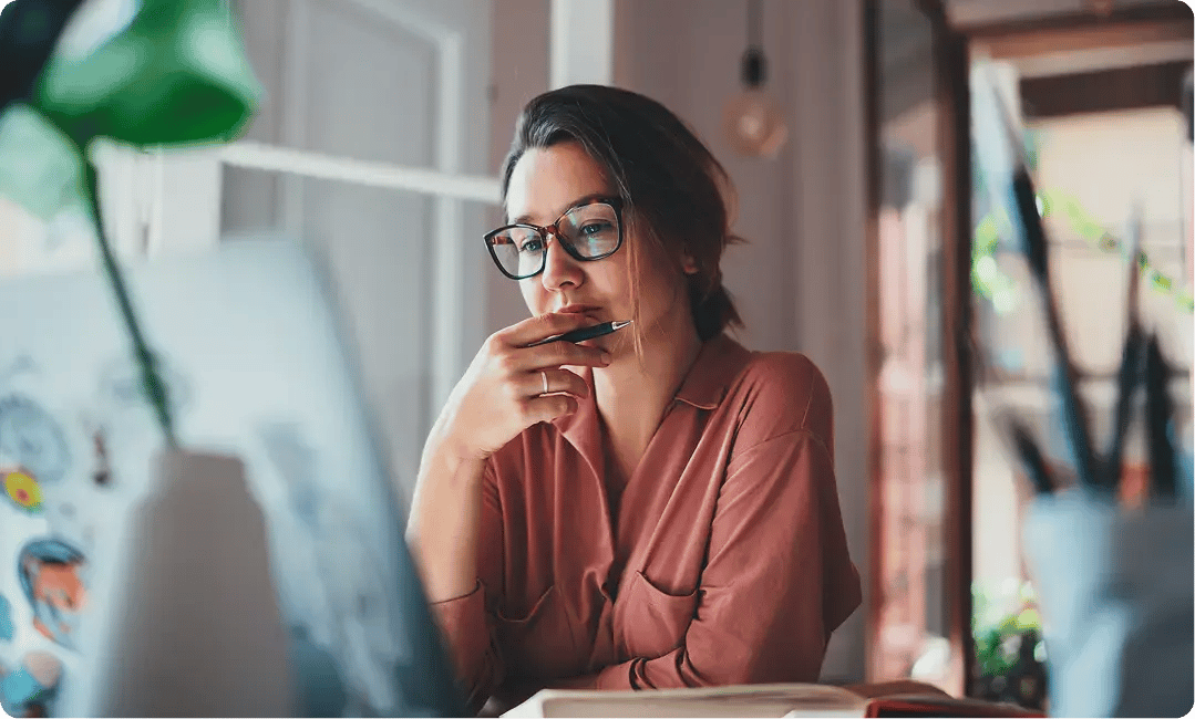 Design studio owner reviewing client feedback on her computer