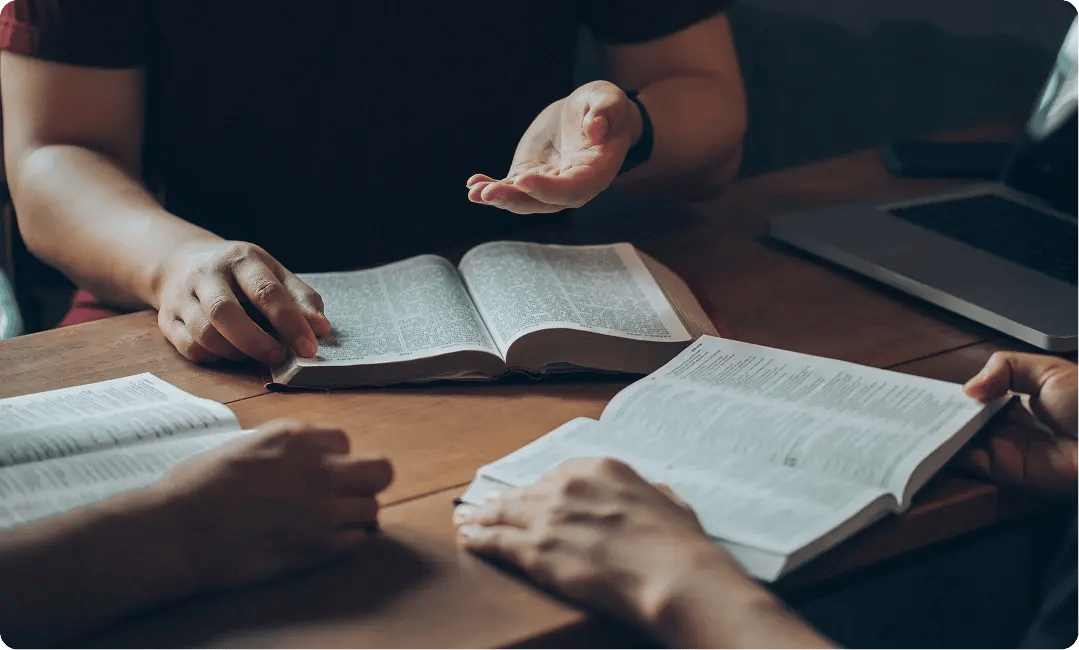 Team members discussing Bible passages during a collaborative study session