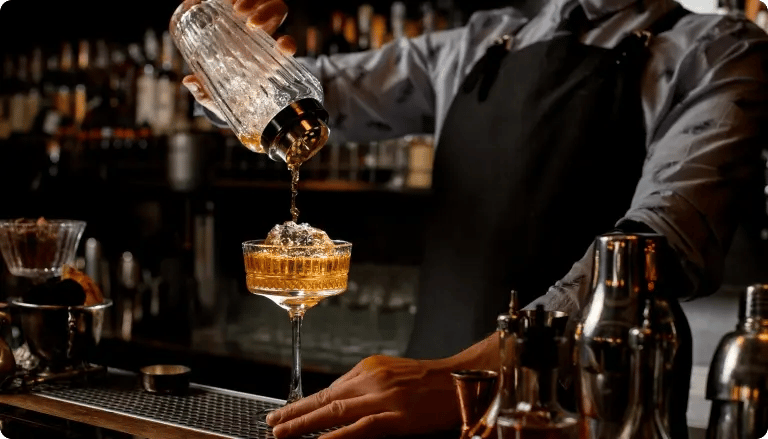 Bartender pouring a cocktail during a branded hospitality experience