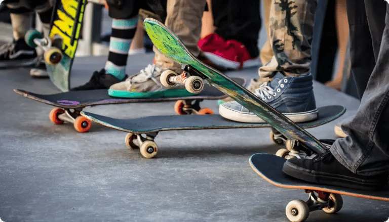 Group of skateboarders standing with their boards at a skatepark