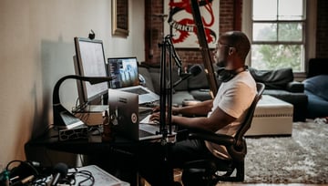 Grown man sitting in front of his computer desk